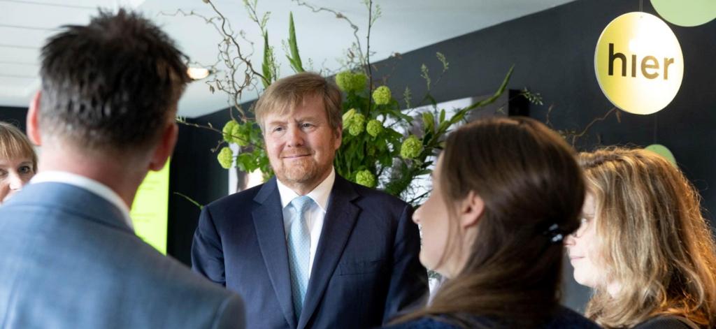 Foto van koning Willem-Alexander in gesprek met collega's van HIER