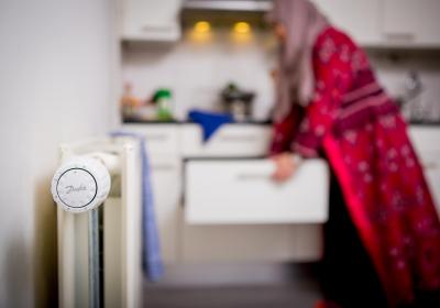 Foto van een radiator in een keuken en een vrouw